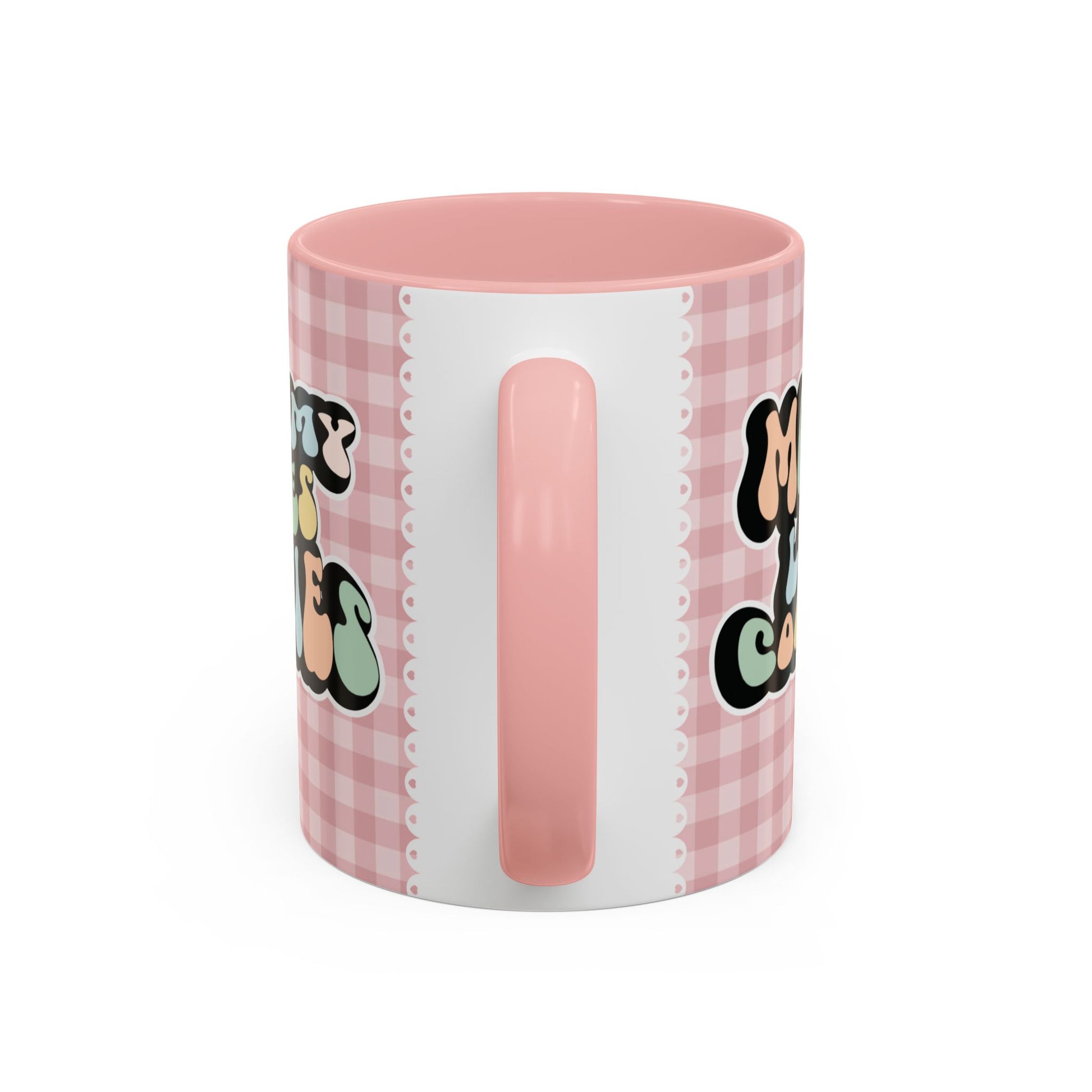 Perfect gift for mom. A decorative, 11oz ceramic mug. It’s wrapped in a soft pink-white checkered background. In a happy and colorful 70s retro-style font it says Mommy Loves Cookies, on both sides.