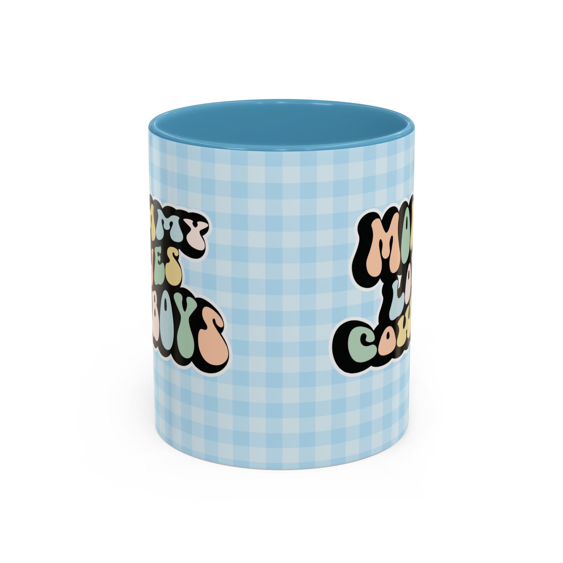 Perfect gift for mom. A decorative, 11oz ceramic mug. It’s wrapped in a light blue-white checkered background. In a happy and colorful 70s retro-style font it says Mommy Loves Cowboys, on both sides.