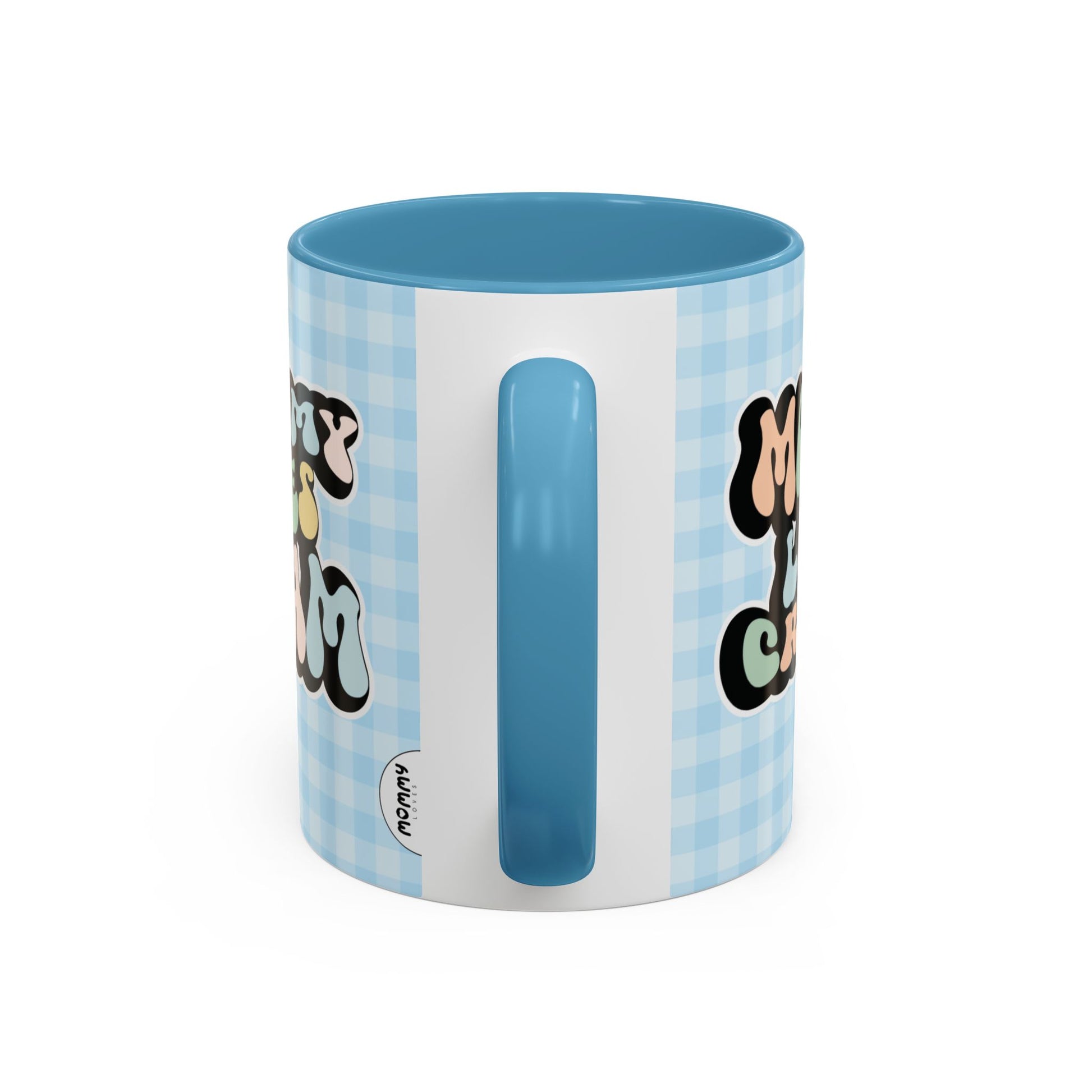 Perfect gift for mom. A decorative, 11oz ceramic mug. It’s wrapped in a light blue-white checkered background. In a happy and colorful 70s retro-style font it says Mommy Loves Cream, on both sides.