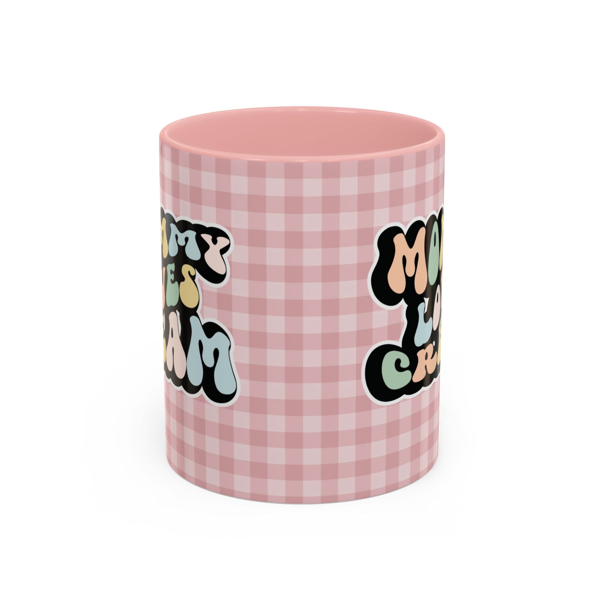 Perfect gift for mom. A decorative, 11oz ceramic mug. It’s wrapped in a soft pink-white checkered background. In a happy and colorful 70s retro-style font it says Mommy Loves Cream, on both sides.
