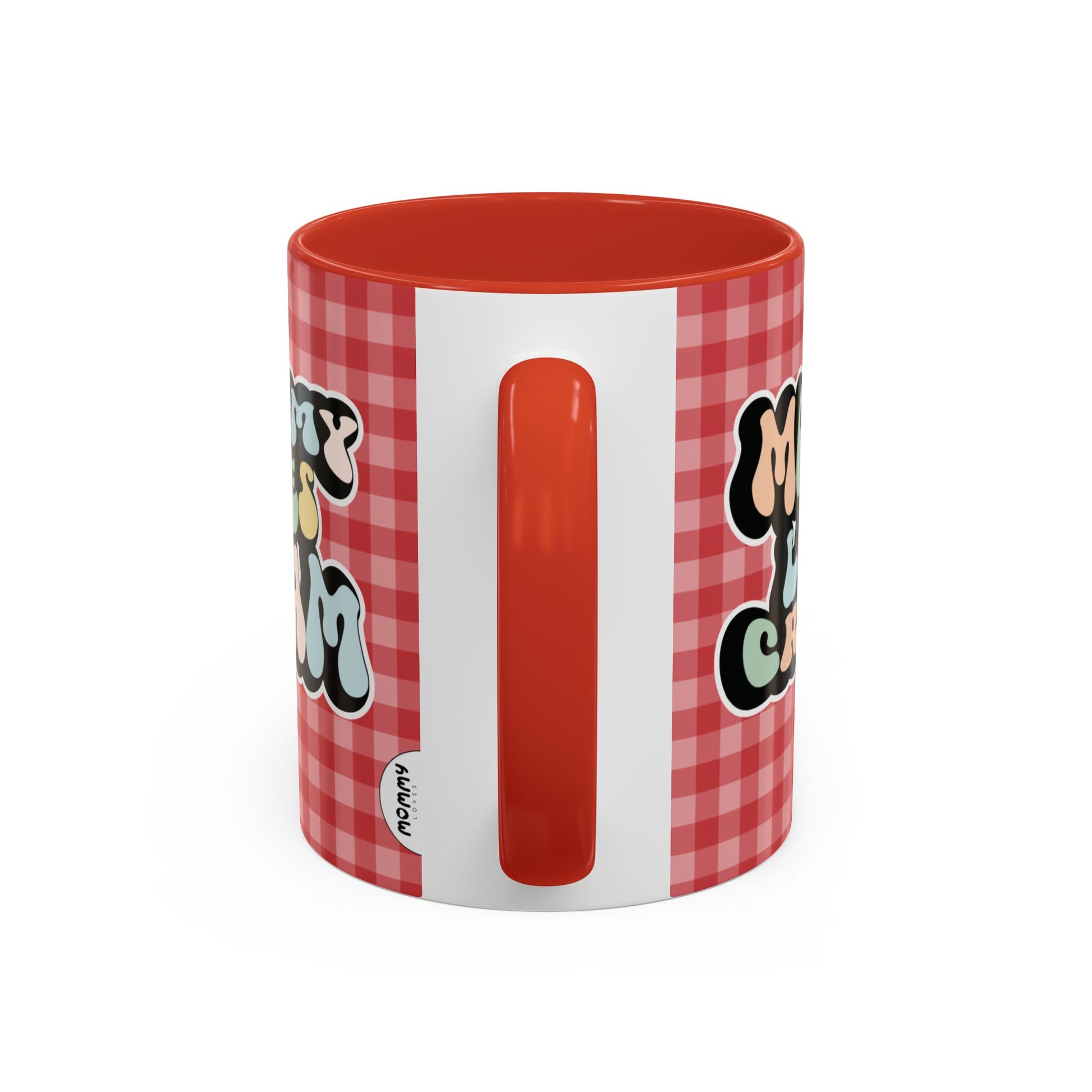Perfect gift for mom. A decorative, 11oz ceramic mug. It’s wrapped in a red-white checkered background. In a happy and colorful 70s retro-style font it says Mommy Loves Cream, on both sides.
