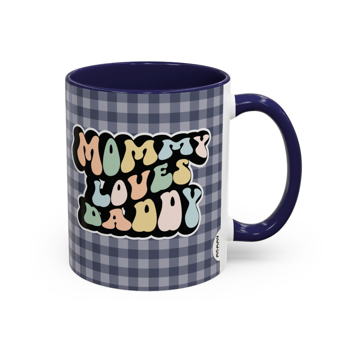 Perfect gift for mom. A decorative, 11oz ceramic mug. It’s wrapped in a navy blue-white checkered background. In a happy and colorful 70s retro-style font it says Mommy Loves Daddy, on both sides.