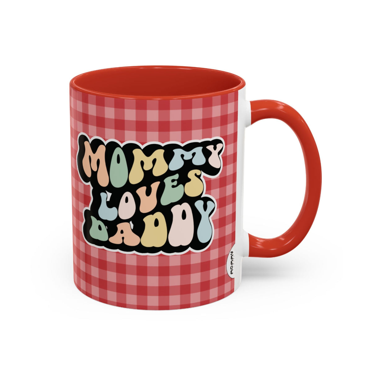 Perfect gift for mom. A decorative, 11oz ceramic mug. It’s wrapped in a red-white checkered background. In a happy and colorful 70s retro-style font it says Mommy Loves Daddy, on both sides.