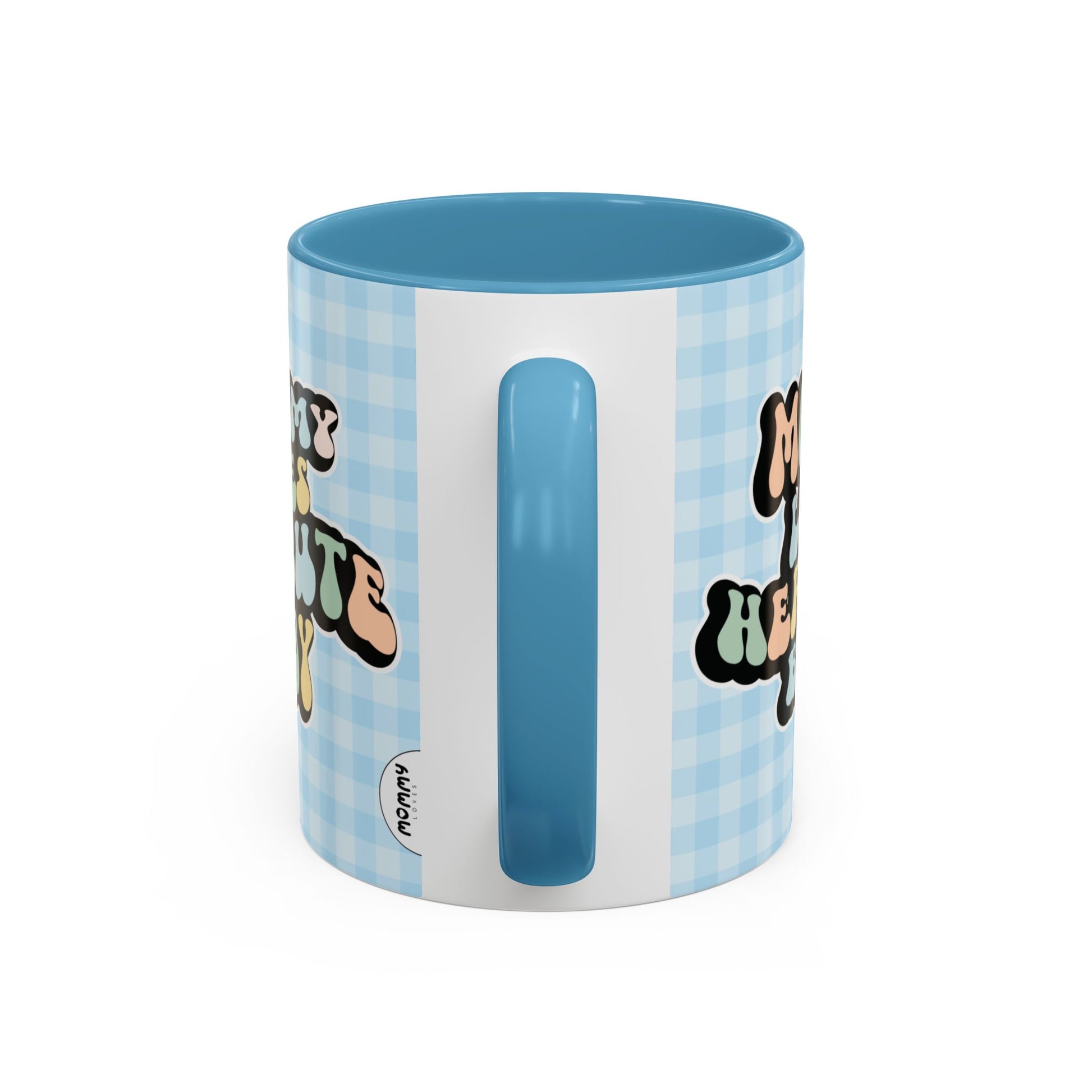 Perfect gift for mom. A decorative, 11oz ceramic mug. It’s wrapped in a light blue-white checkered background. In a happy and colorful 70s retro-style font it says Mommy Loves Her Cute Baby, on both sides.