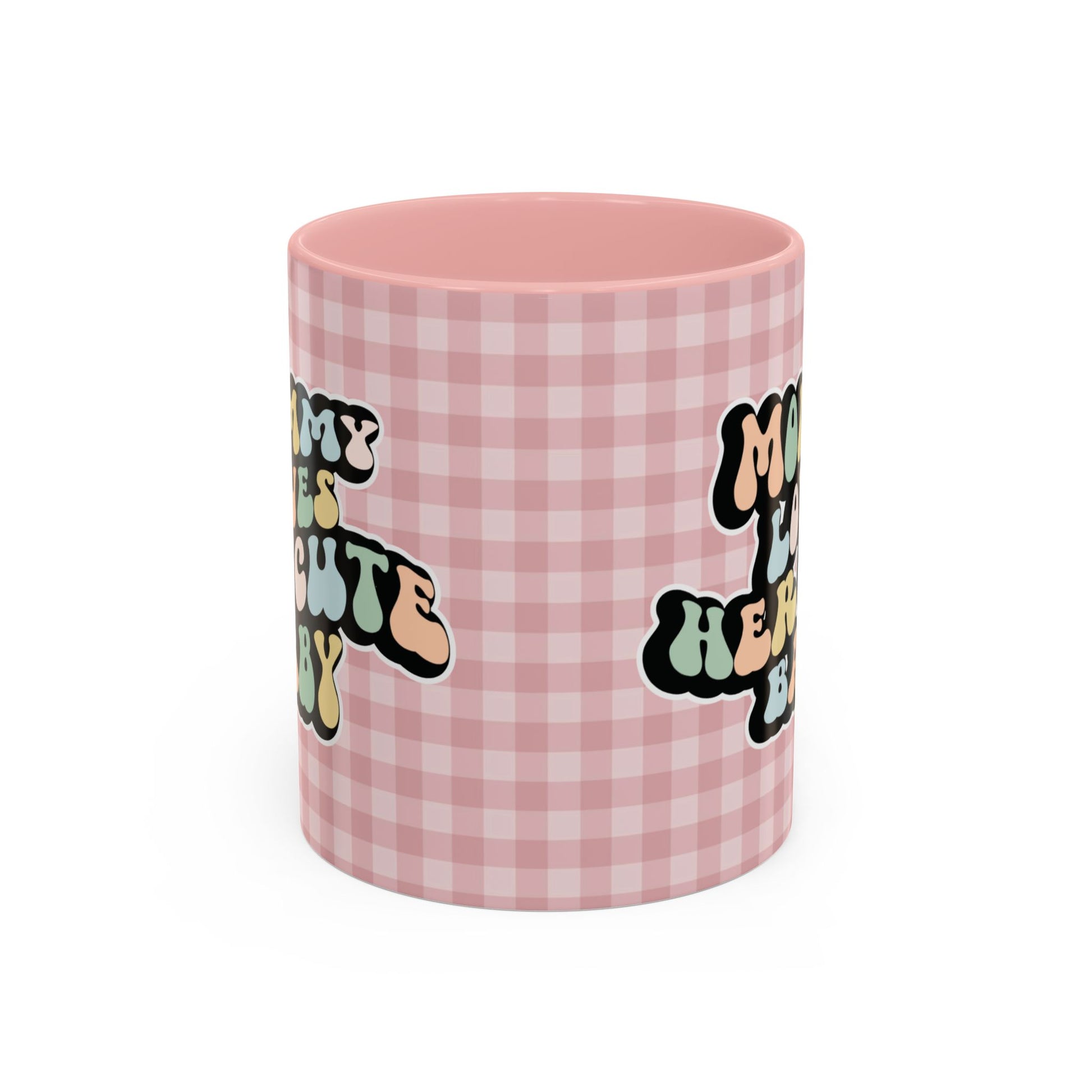 Perfect gift for mom. A decorative, 11oz ceramic mug. It’s wrapped in a soft pink-white checkered background. In a happy and colorful 70s retro-style font it says Mommy Loves Her Cute Baby, on both sides.