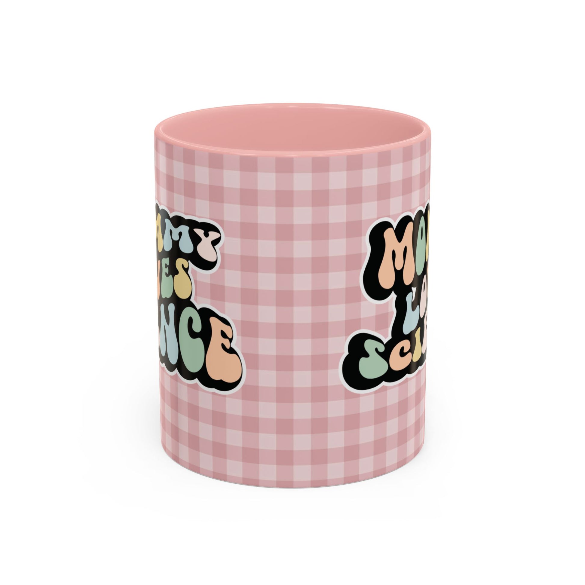 Perfect gift for mom. A decorative, 11oz ceramic mug. It’s wrapped in a soft pink-white checkered background. In a happy and colorful 70s retro-style font it says Mommy Loves Science, on both sides.