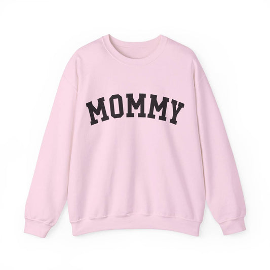 The perfect gift for mom. Our Mother’s Day special. Our crewneck sweatshirt. The color of the shirt is light pink, and in big black varsity letters it says MOMMY on the chest. It’s available in six sizes, ranging from S to 3XL.