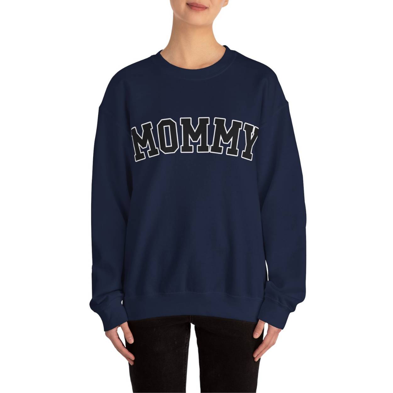 The perfect gift for mom. Our Mother’s Day special. The model is wearing our crewneck sweatshirt. The color of the shirt is navy blue, and in big varsity letters it says MOMMY on the chest. It’s available in six sizes, ranging from S to 3XL.