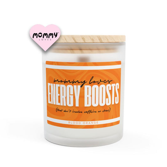 The perfect gift for mom, especially for mother's day. A frosted glass scented candle, with a wooden lid. The glass vessel is 11 oz, and the wax is 9oz. Burning time is around 50 hours. The label is beautifully designed in orange colors, and it says: Mommy Loves Energy Boosts. Underneath, in between brackets it says: that don't involve caffeine or chaos. A funny, yet original gift for mom! The scent is blood orange. Super Energizing.