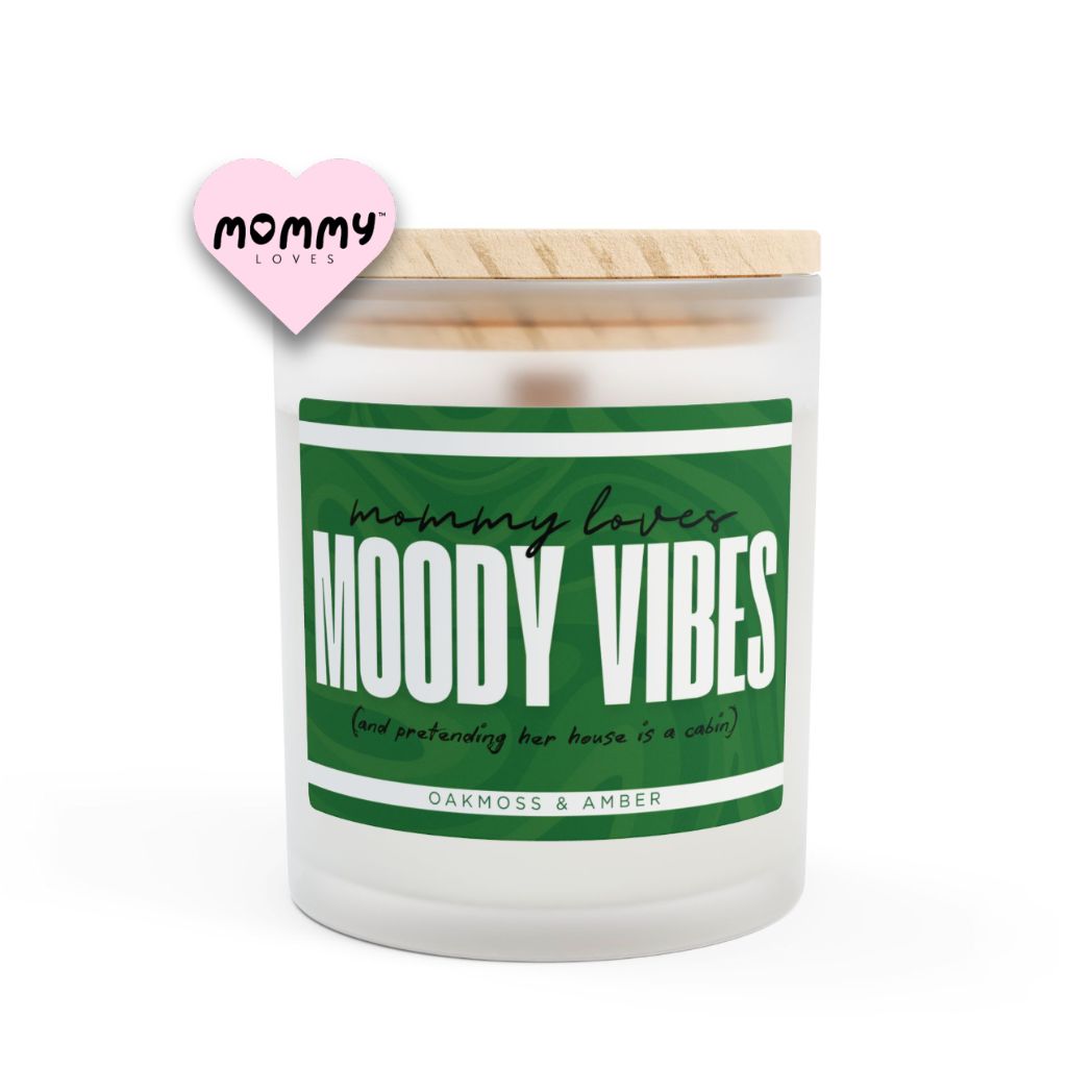The perfect gift for mom, especially for mother's day. A frosted glass scented candle, with a wooden lid. The glass vessel is 11 oz, and the wax is 9oz. Burning time is around 50 hours. The label is beautifully designed in forest green colors, and it says: Mommy Loves Moody Vibes. Underneath, in between brackets it says: and pretending her house is a cabin A funny, yet original gift for mom! The fragrance is oakmoss and amber. Super relaxing.