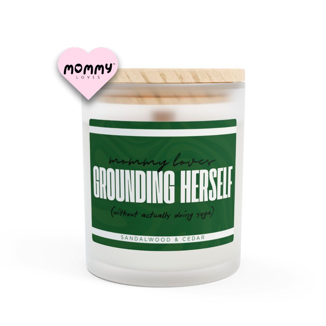 The perfect gift for mom, especially for mother's day. A frosted glass scented candle, with a wooden lid. The glass vessel is 11 oz, and the wax is 9oz. Burning time is around 50 hours. The label is beautifully designed in dark green colors, and it says: Mommy Loves Grounding Herself. Underneath, in between brackets it says: without actually doing yoga. A funny, yet original gift for mom! The fragrance is sandalwood & cedar. Super relaxing.
