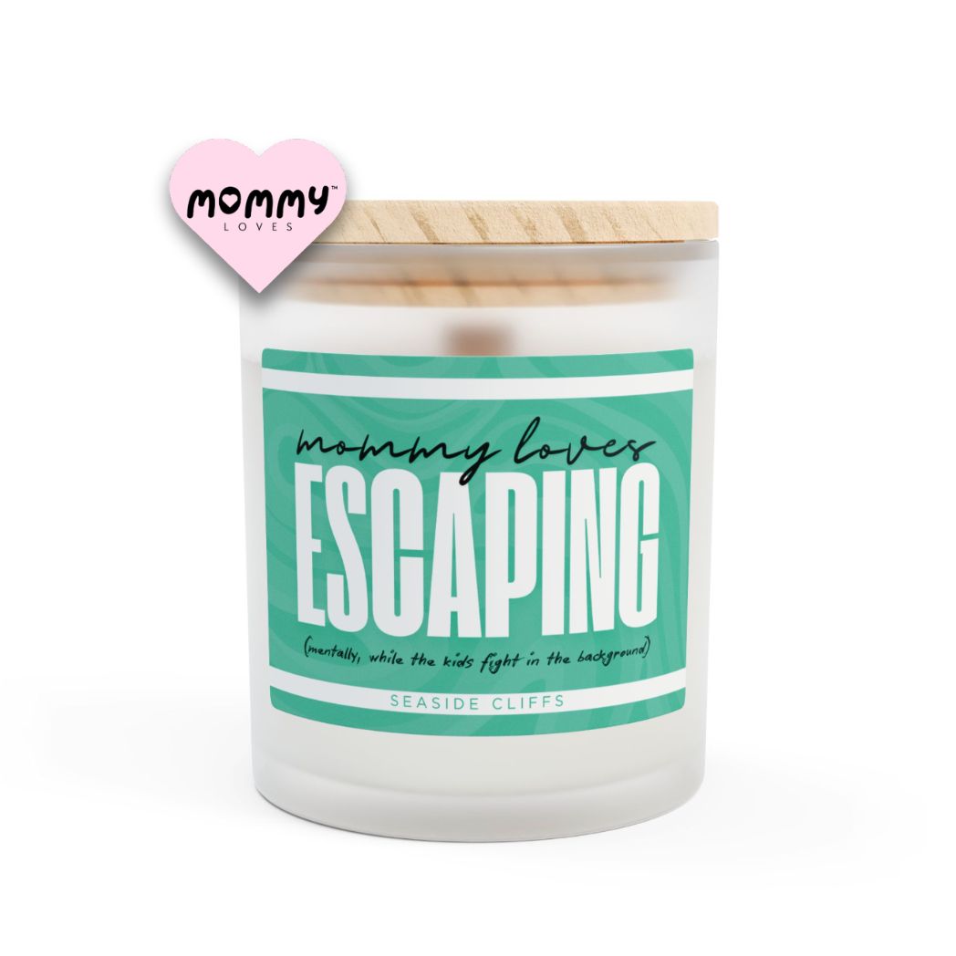 The perfect gift for mom, especially for mother's day. A frosted glass scented candle, with a wooden lid. The glass vessel is 11 oz, and the wax is 9oz. Burning time is around 50 hours. The label is beautifully designed in cyan green/blue colors, and it says: Mommy Loves Escaping. Underneath, in between brackets it says: mentally, while the kids fight i the background. A funny, yet original gift for mom! The fragrance is seaside cliffs. Super relaxing.