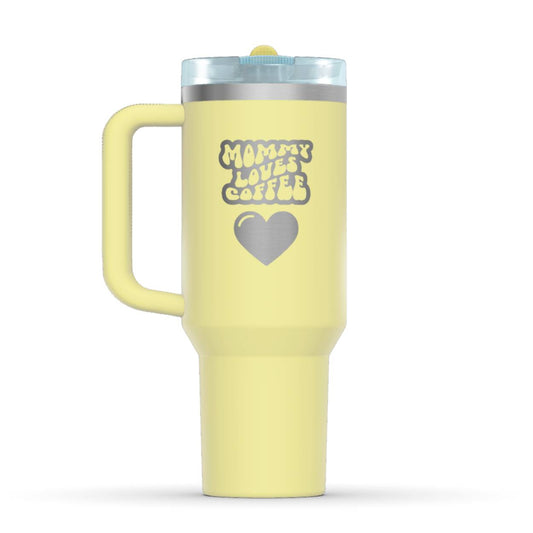 Stanley 40oz Tumbler, with a personalized twist. The perfect gift for mom. The Color of the cup is Pomelo Yellow. It’s engraved with a typically 70s retro-style font, saying Mommy Loves Coffee. Under that text there is a nice big heart in the same style.