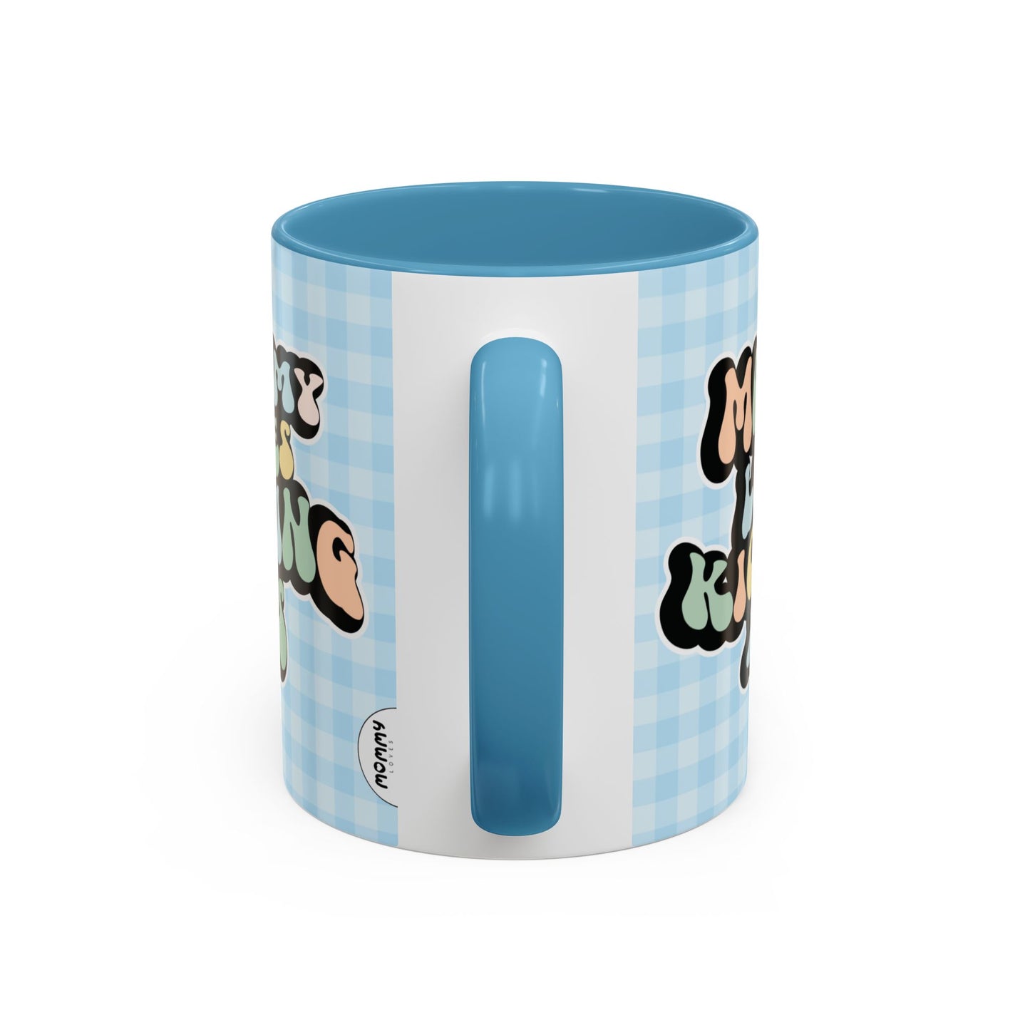 Perfect gift for mom. A decorative, 11oz ceramic mug. It’s wrapped in a light blue-white checkered background. In a happy and colorful 70s retro-style font it says Mommy Loves Kicking Ass on both sides. 