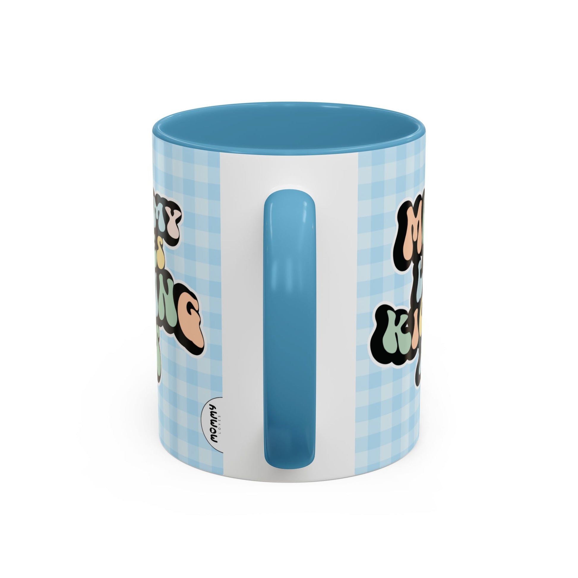 Perfect gift for mom. A decorative, 11oz ceramic mug. It’s wrapped in a light blue-white checkered background. In a happy and colorful 70s retro-style font it says Mommy Loves Kicking Ass on both sides. 