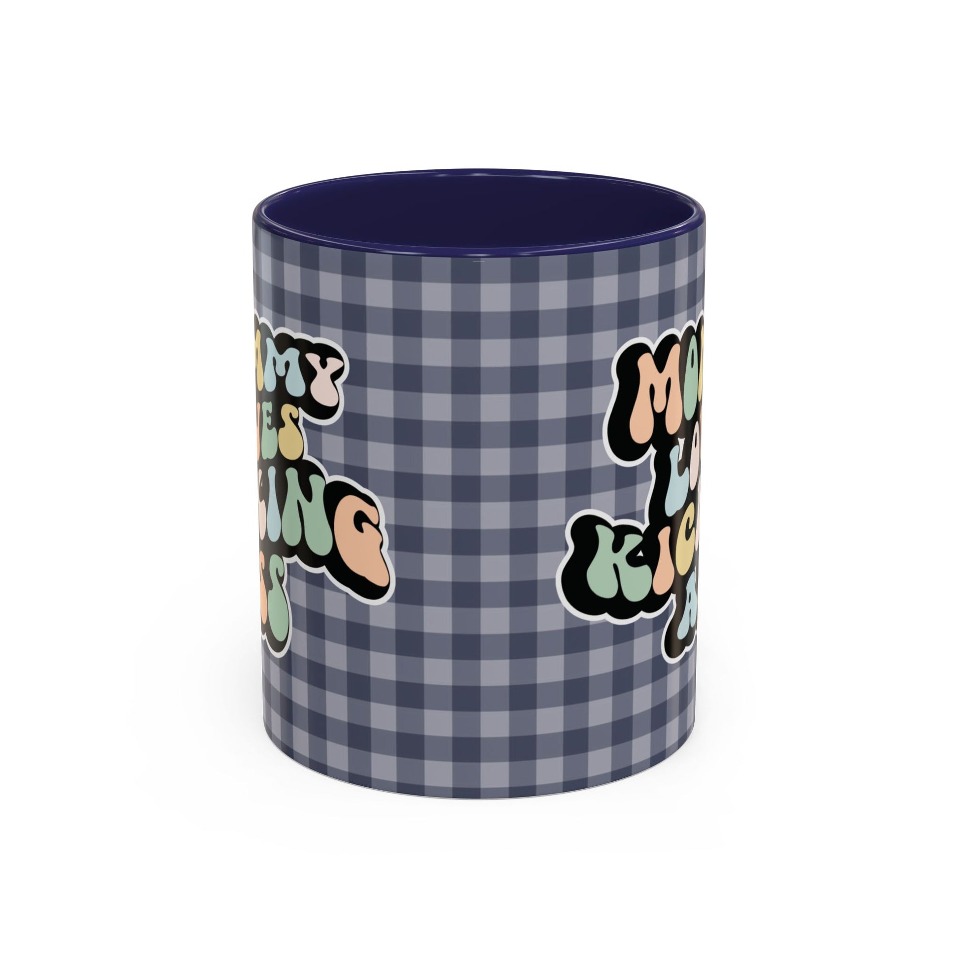 Perfect gift for mom. A decorative, 11oz ceramic mug. It’s wrapped in a navy blue-white checkered background. In a happy and colorful 70s retro-style font it says Mommy Loves Kicking Ass on both sides. 