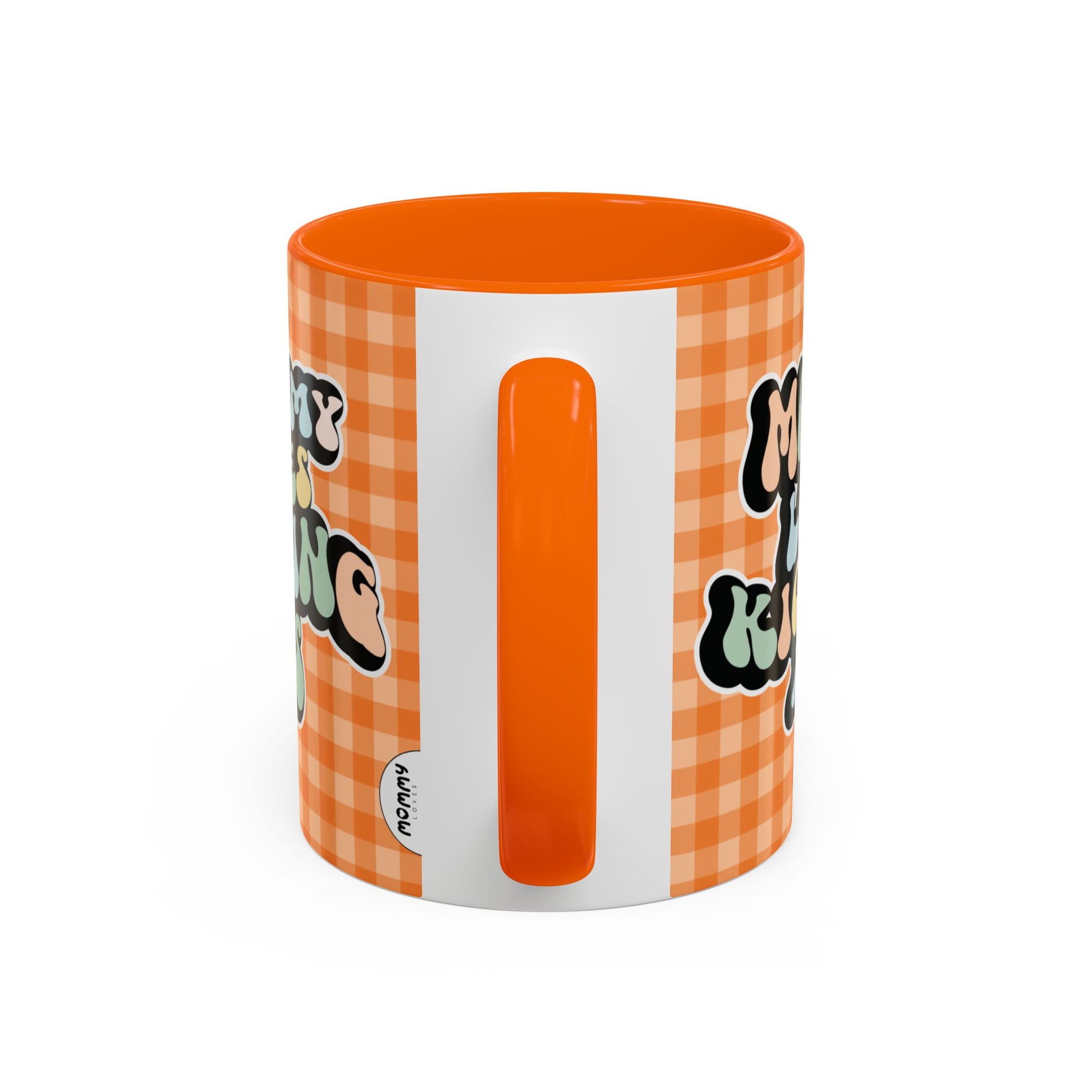 Perfect gift for mom. A decorative, 11oz ceramic mug. It’s wrapped in a orange-white checkered background. In a happy and colorful 70s retro-style font it says Mommy Loves Kicking Ass on both sides. 