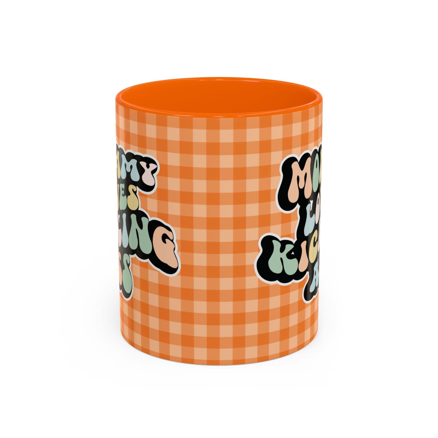 Perfect gift for mom. A decorative, 11oz ceramic mug. It’s wrapped in a orange-white checkered background. In a happy and colorful 70s retro-style font it says Mommy Loves Kicking Ass on both sides. 