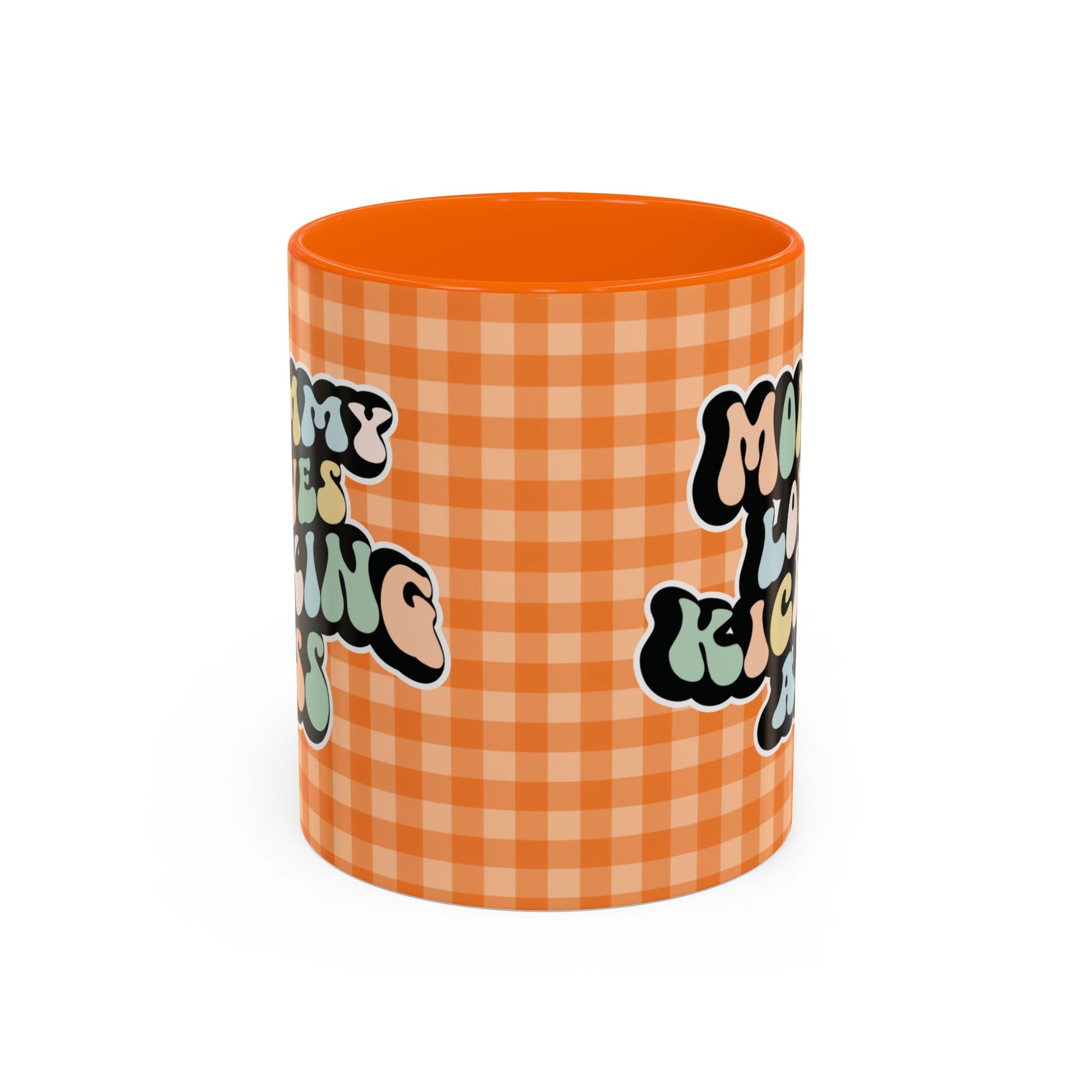 Perfect gift for mom. A decorative, 11oz ceramic mug. It’s wrapped in a orange-white checkered background. In a happy and colorful 70s retro-style font it says Mommy Loves Kicking Ass on both sides. 