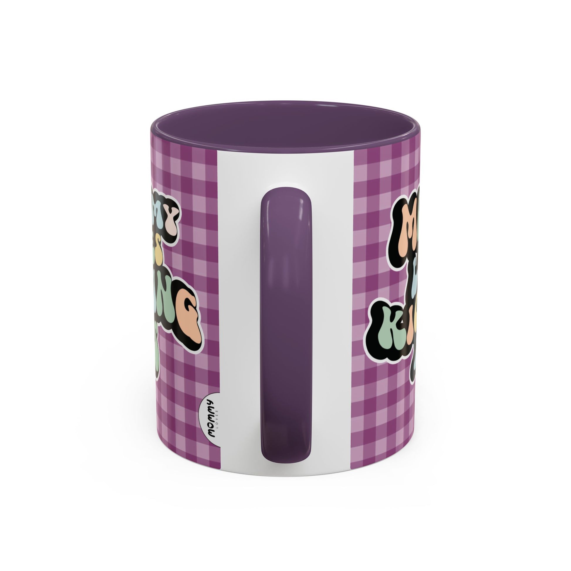 Perfect gift for mom. A decorative, 11oz ceramic mug. It’s wrapped in a purple-white checkered background. In a happy and colorful 70s retro-style font it says Mommy Loves Kicking Ass on both sides. 