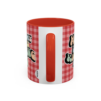 Perfect gift for mom. A decorative, 11oz ceramic mug. It’s wrapped in a red-white checkered background. In a happy and colorful 70s retro-style font it says Mommy Loves Kicking Ass on both sides. 