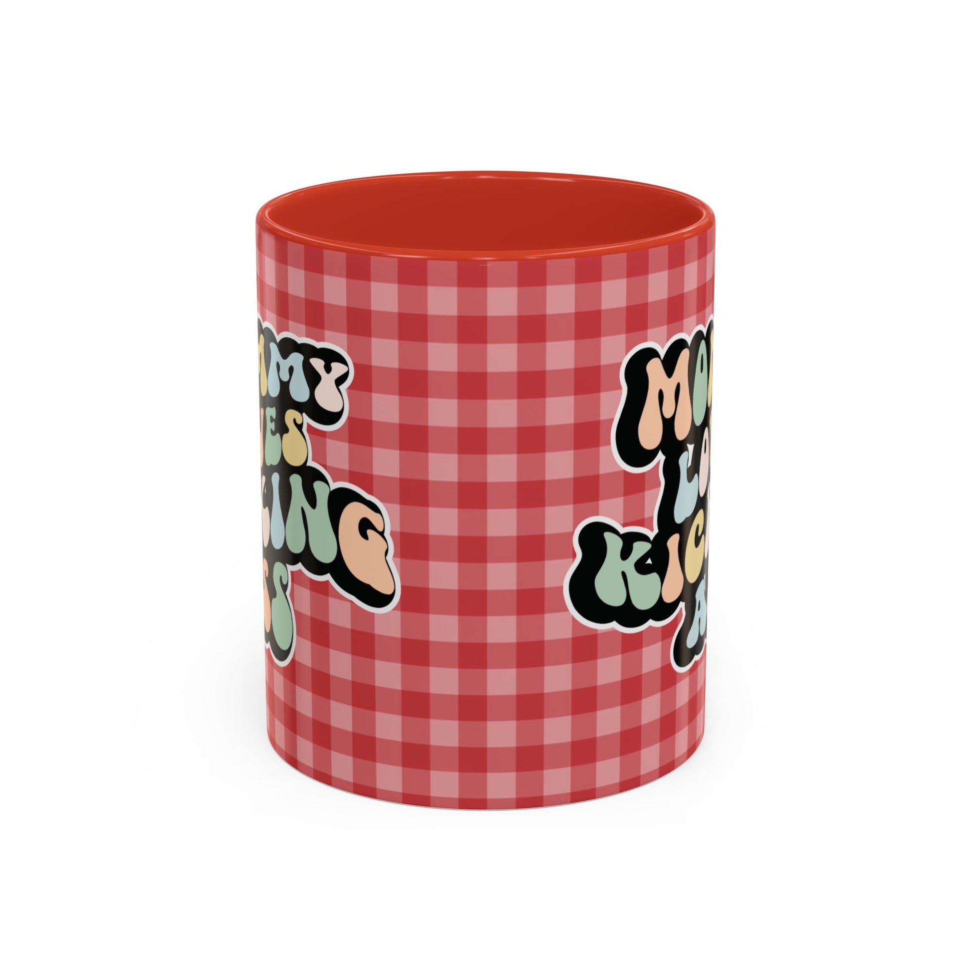 Perfect gift for mom. A decorative, 11oz ceramic mug. It’s wrapped in a red-white checkered background. In a happy and colorful 70s retro-style font it says Mommy Loves Kicking Ass on both sides. 