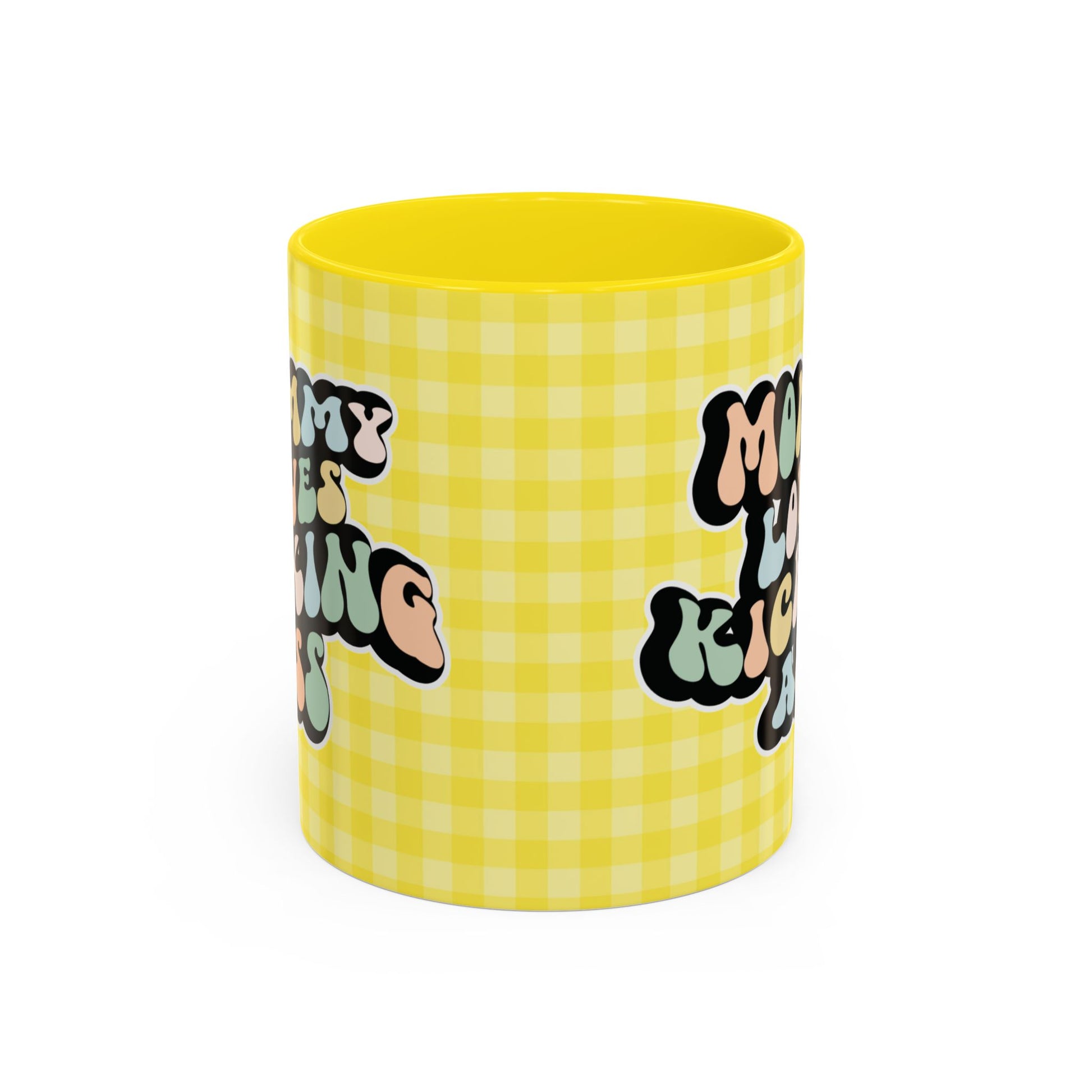 Perfect gift for mom. A decorative, 11oz ceramic mug. It’s wrapped in a yellow-white checkered background. In a happy and colorful 70s retro-style font it says Mommy Loves Kicking Ass on both sides. 