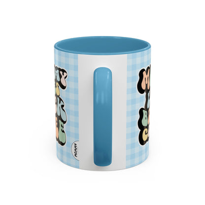 Perfect gift for mom. A decorative, 11oz ceramic mug. It’s wrapped in a light blue-white checkered background. In a happy and colorful 70s retro-style font it says Mommy Loves Black Coffee on both sides. 