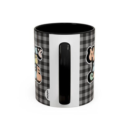 Perfect gift for mom. A decorative, 11oz ceramic mug. It’s wrapped in a black-white checkered background. In a happy and colorful 70s retro-style font it says Mommy Loves Coffee, on both sides. 