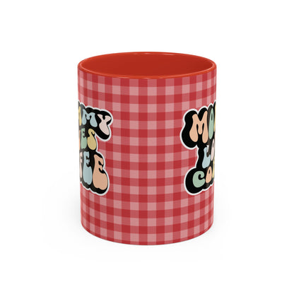 Perfect gift for mom. A decorative, 11oz ceramic mug. It’s wrapped in a red-white checkered background. In a happy and colorful 70s retro-style font it says Mommy Loves Coffee, on both sides. 