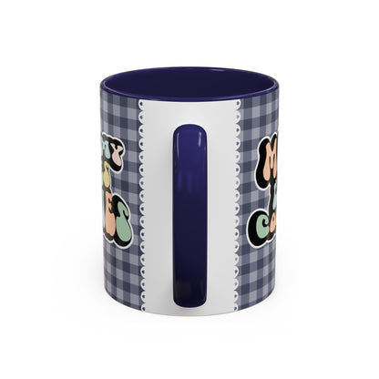 Perfect gift for mom. A decorative, 11oz ceramic mug. It’s wrapped in a navy blue-white checkered background. In a happy and colorful 70s retro-style font it says Mommy Loves Cookies, on both sides. 
