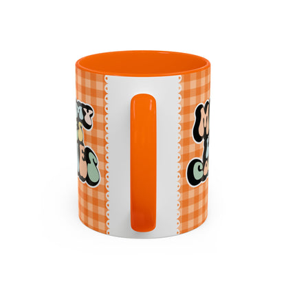 Perfect gift for mom. A decorative, 11oz ceramic mug. It’s wrapped in a orange-white checkered background. In a happy and colorful 70s retro-style font it says Mommy Loves Cookies, on both sides. 