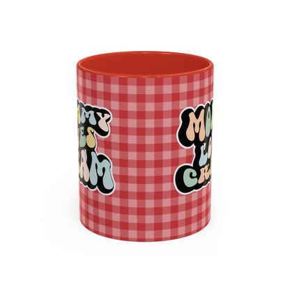 Perfect gift for mom. A decorative, 11oz ceramic mug. It’s wrapped in a red-white checkered background. In a happy and colorful 70s retro-style font it says Mommy Loves Cream, on both sides. 