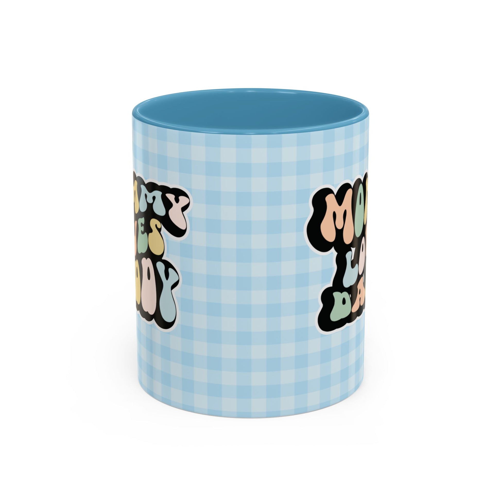 Perfect gift for mom. A decorative, 11oz ceramic mug. It’s wrapped in a light blue-white checkered background. In a happy and colorful 70s retro-style font it says Mommy Loves Daddy, on both sides. 