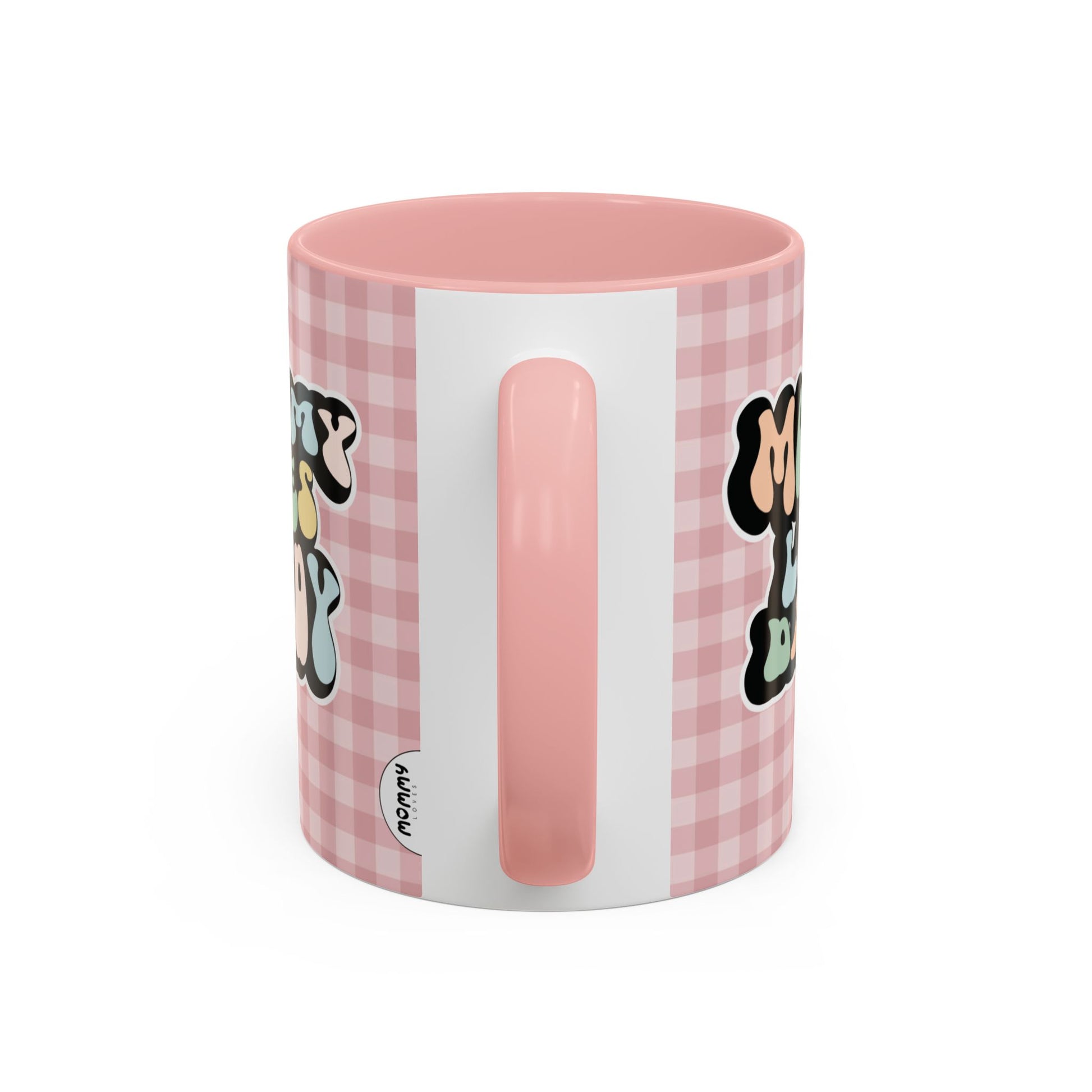 Perfect gift for mom. A decorative, 11oz ceramic mug. It’s wrapped in a soft pink-white checkered background. In a happy and colorful 70s retro-style font it says Mommy Loves Daddy, on both sides. 