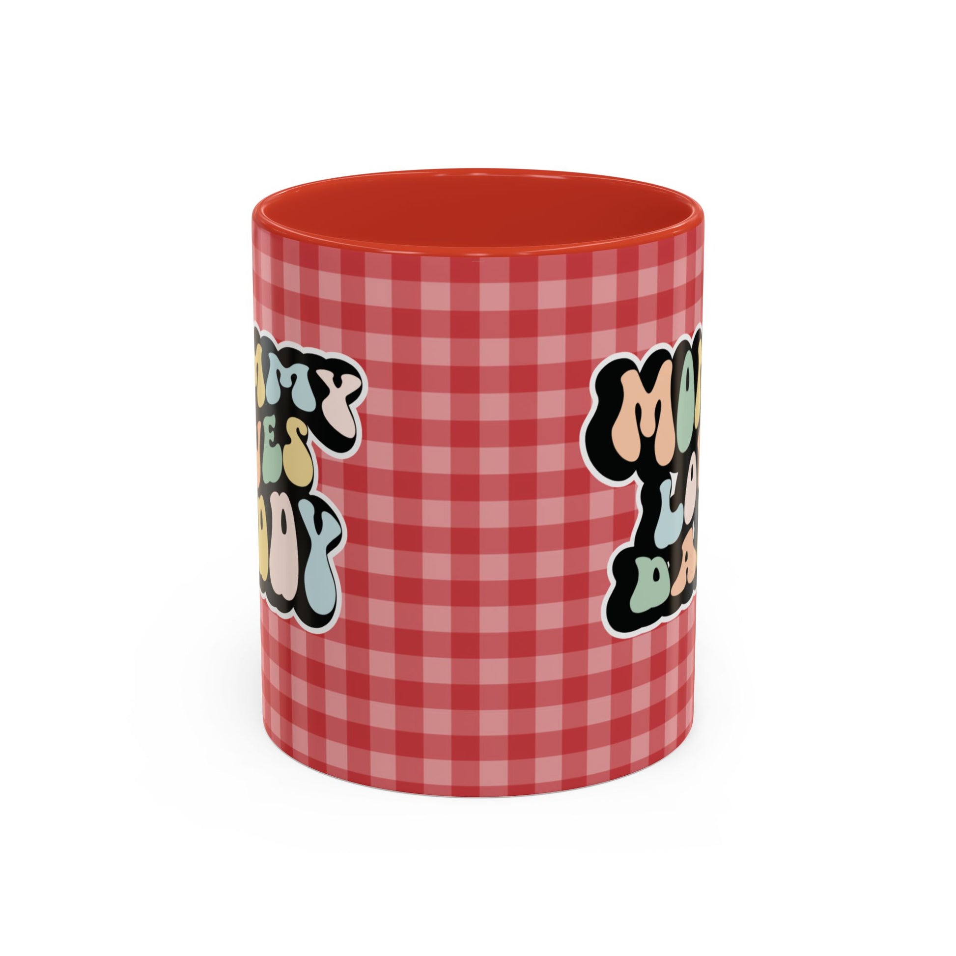 Perfect gift for mom. A decorative, 11oz ceramic mug. It’s wrapped in a red-white checkered background. In a happy and colorful 70s retro-style font it says Mommy Loves Daddy, on both sides. 