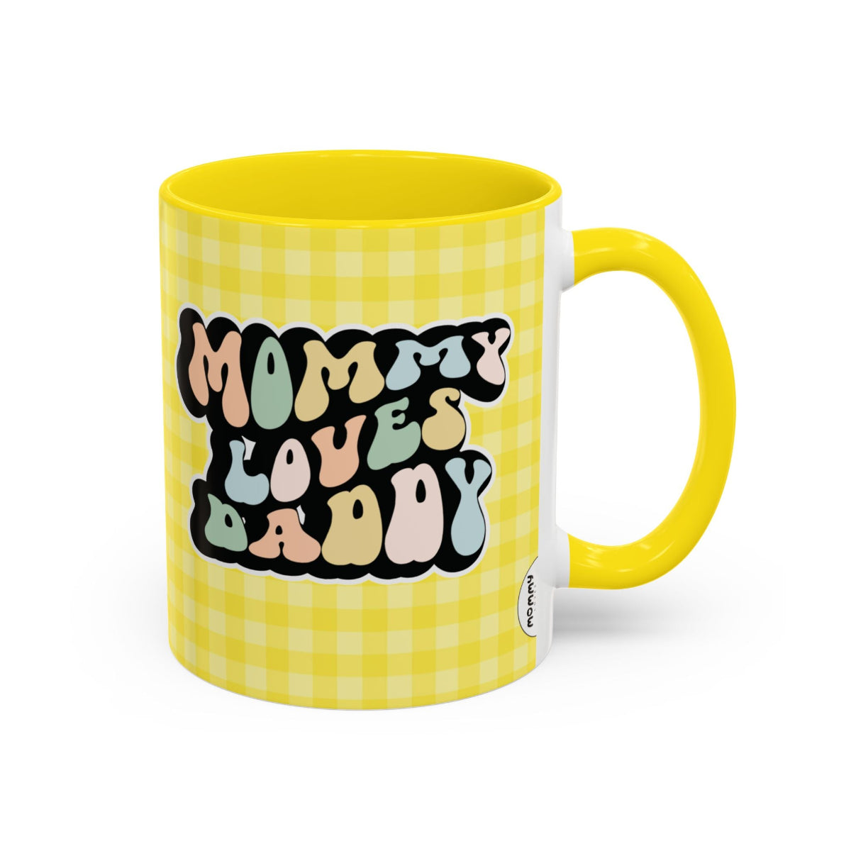 Perfect gift for mom. A decorative, 11oz ceramic mug. It’s wrapped in a yellow-white checkered background. In a happy and colorful 70s retro-style font it says Mommy Loves Daddy, on both sides. 