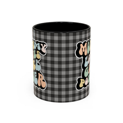 Perfect gift for mom. A decorative, 11oz ceramic mug. It’s wrapped in a black-white checkered background. In a happy and colorful 70s retro-style font it says Mommy Loves Girl Power, on both sides. 