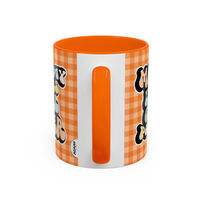Perfect gift for mom. A decorative, 11oz ceramic mug. It’s wrapped in a orange-white checkered background. In a happy and colorful 70s retro-style font it says Mommy Loves Girl Power, on both sides. 