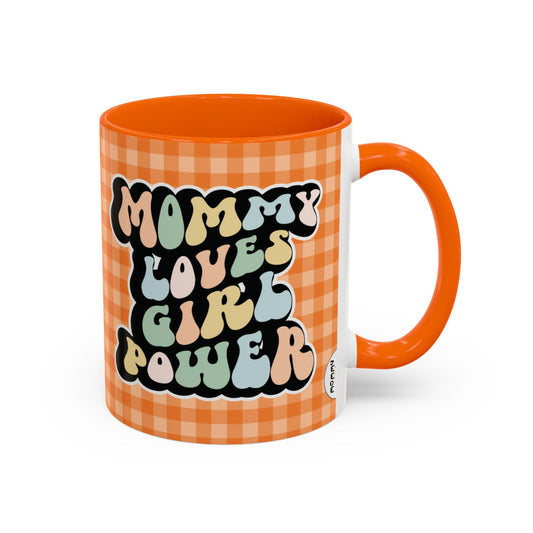 Perfect gift for mom. A decorative, 11oz ceramic mug. It’s wrapped in a orange-white checkered background. In a happy and colorful 70s retro-style font it says Mommy Loves Girl Power, on both sides. 
