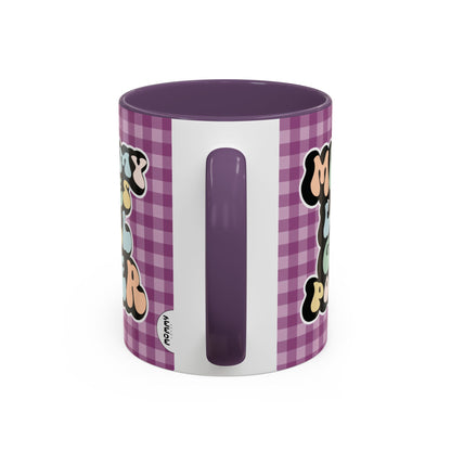 Perfect gift for mom. A decorative, 11oz ceramic mug. It’s wrapped in a purple-white checkered background. In a happy and colorful 70s retro-style font it says Mommy Loves Girl Power, on both sides. 