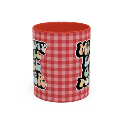 Perfect gift for mom. A decorative, 11oz ceramic mug. It’s wrapped in a red-white checkered background. In a happy and colorful 70s retro-style font it says Mommy Loves Girl Power, on both sides. 