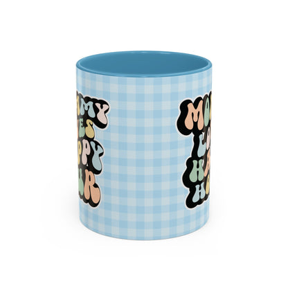 Perfect gift for mom. A decorative, 11oz ceramic mug. It’s wrapped in a light blue-white checkered background. In a happy and colorful 70s retro-style font it says Mommy Loves Happy Hour, on both sides. 