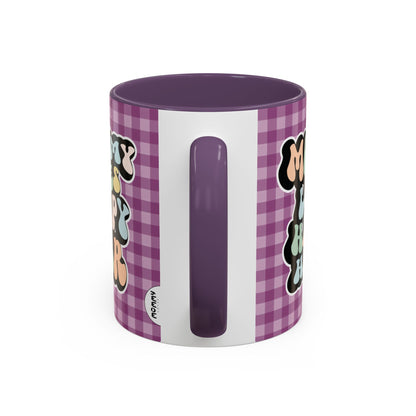 Perfect gift for mom. A decorative, 11oz ceramic mug. It’s wrapped in a purple-white checkered background. In a happy and colorful 70s retro-style font it says Mommy Loves Happy Hour, on both sides. 