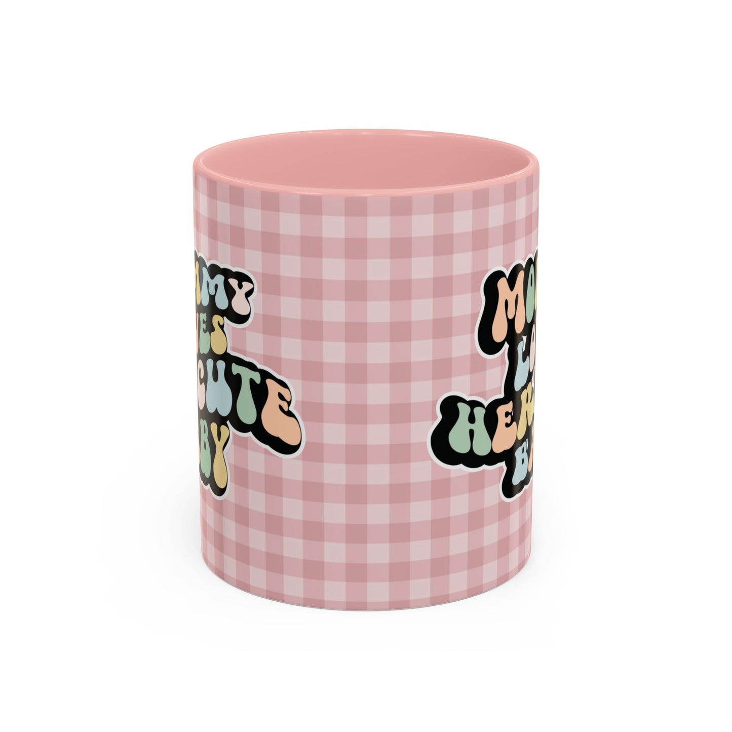 Perfect gift for mom. A decorative, 11oz ceramic mug. It’s wrapped in a soft pink-white checkered background. In a happy and colorful 70s retro-style font it says Mommy Loves Her Cute Baby, on both sides. 