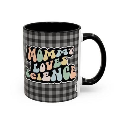 Perfect gift for mom. A decorative, 11oz ceramic mug. It’s wrapped in a black-white checkered background. In a happy and colorful 70s retro-style font it says Mommy Loves Science, on both sides.