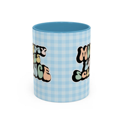 Perfect gift for mom. A decorative, 11oz ceramic mug. It’s wrapped in a light blue-white checkered background. In a happy and colorful 70s retro-style font it says Mommy Loves Science, on both sides.