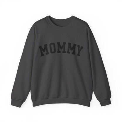 The perfect gift for mom. Our Mother’s Day special. Our crewneck sweatshirt. The color of the shirt is dark heather, and in big black varsity letters it says MOMMY on the chest. It’s available in six sizes, ranging from S to 3XL. 