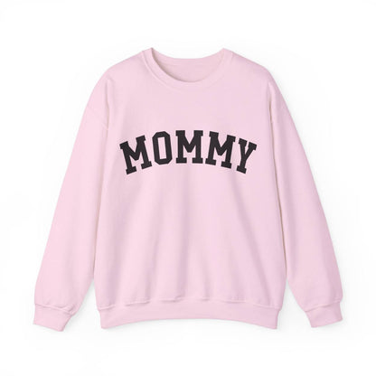 The perfect gift for mom. Our Mother’s Day special. Our crewneck sweatshirt. The color of the shirt is light pink, and in big black varsity letters it says MOMMY on the chest. It’s available in six sizes, ranging from S to 3XL. 