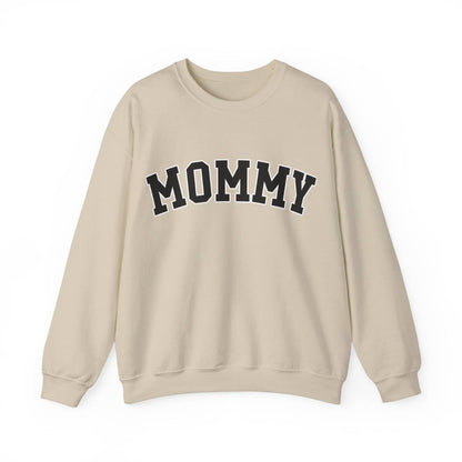 The perfect gift for mom. Our Mother’s Day special. Our crewneck sweatshirt. The color of the shirt is sand, and in big varsity letters it says MOMMY on the chest. It’s available in six sizes, ranging from S to 3XL. 